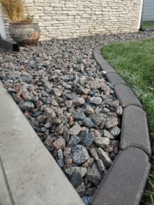river rock flower bed with brick edging